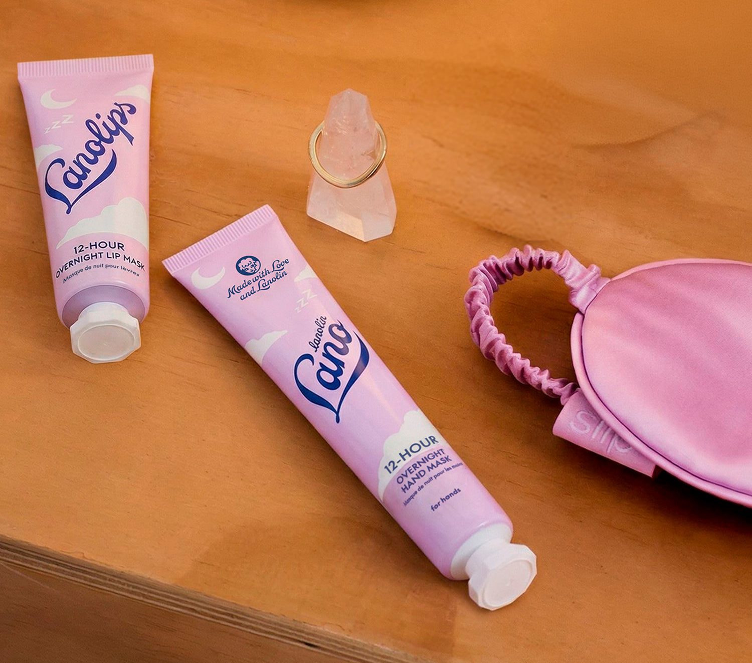 Lanolips 12 Hour Overnight Hand Mask sitting on a bedside table, alongside the 12 Hour Overnight Lip Mask - part of the Lanolips 12 Hour Overnight range. 