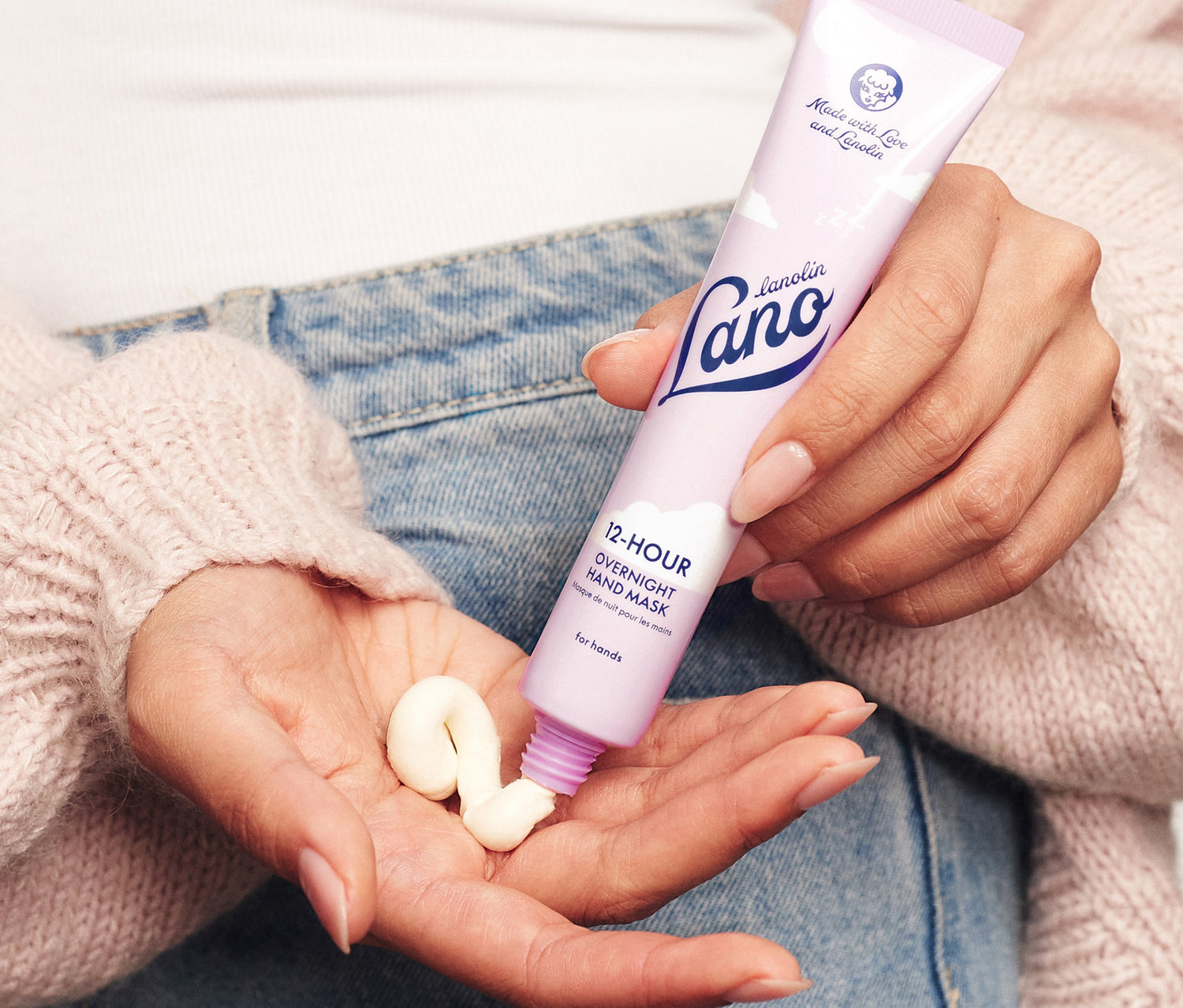 Model holding Lanolips 12 Hour Overnight Hand Mask in her hands. Made with rich lanolin, hyaluronic acid, ceramides and vitamin c to replenish dry hands while you sleep. 