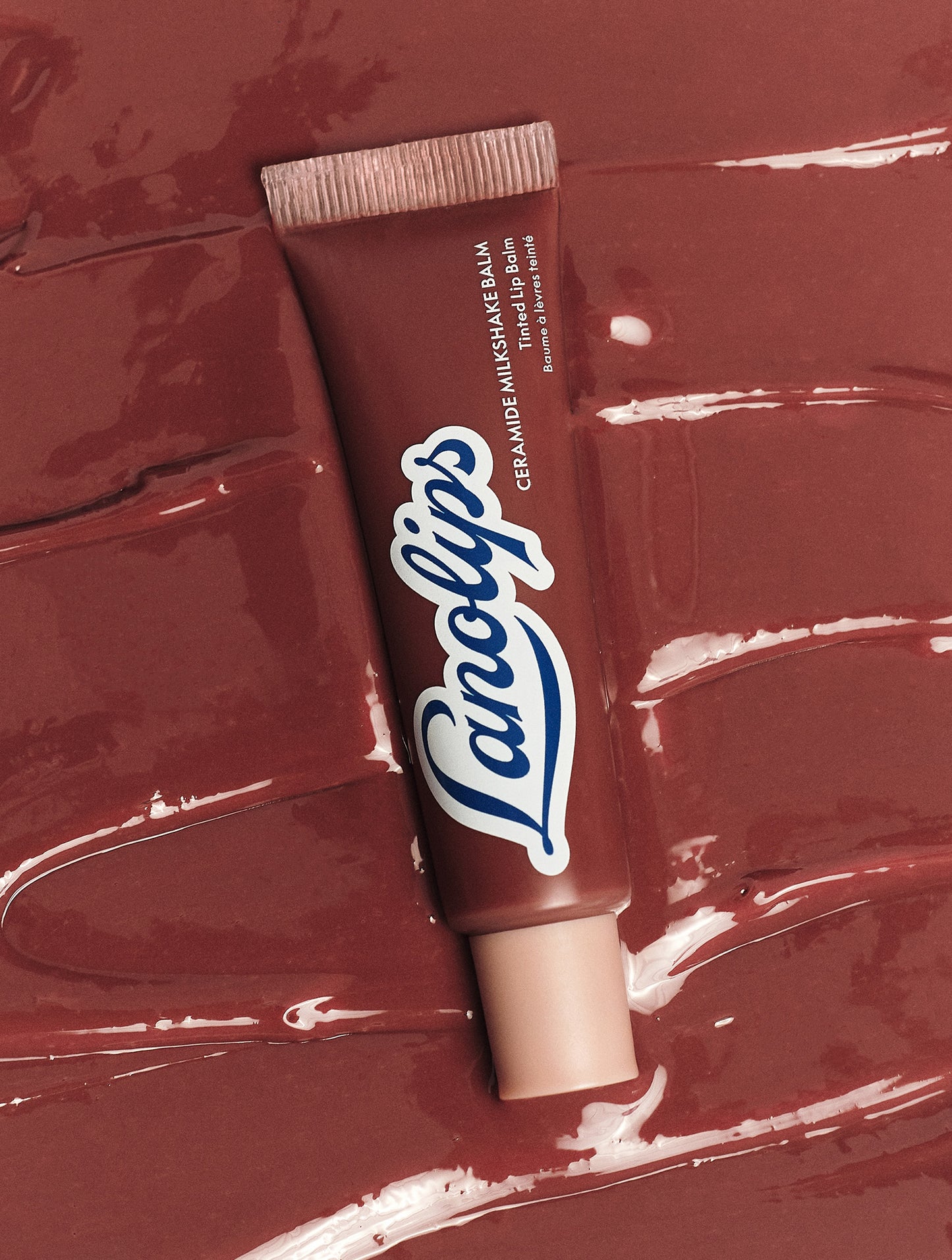 Lanolips Ceramide Milkshake Balm in Caramel Melt on glossy balm texture, a rosy-caramel nude tint made with 90% lanolin, boosted with ceramides and murumuru butter to strengthen the lip barrier