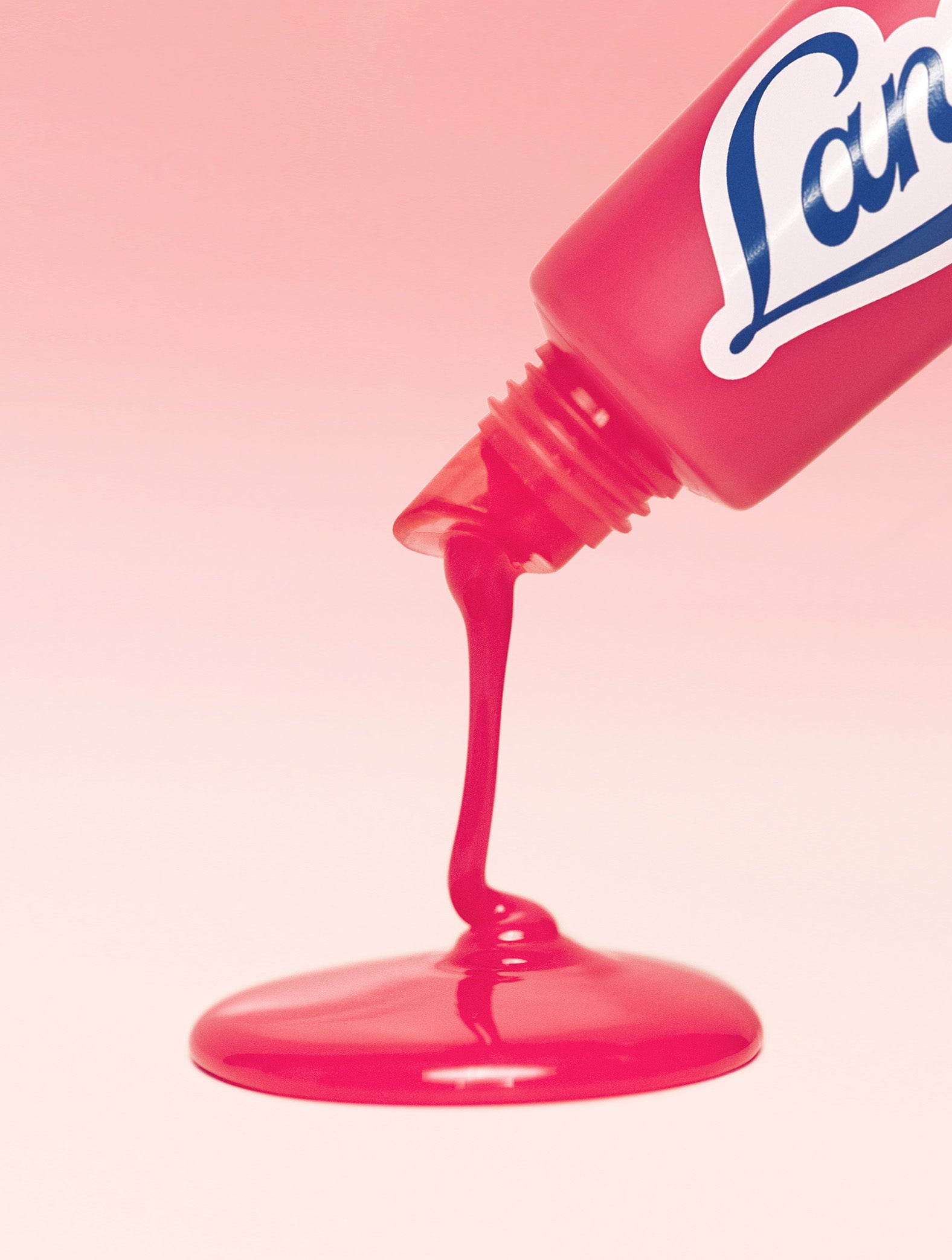 Lanolips Milkshake Ceramide Balm in Raspberry Crumble dispensing glossy, creamy balm showing a sheer raspberry tint. Made with 90% lanolin, boosted with ceramides and murumuru butter to strengthen the lip barrier. 