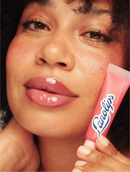 Model wearing Raspberry Crumble Ceramide Milkshake Balm, showing glossy hydrated lips with a sheer creamy raspberry tint. 