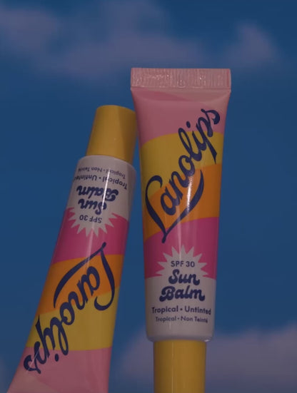 Video of the Lanolips Sun Balm SPF 30 Tropical lip balm - showing montage shots of the product, as well as the model applying the lip balm on their lips. An SPF lip balm you’ll reach for daily, tested to meet global UVA/UVB 
